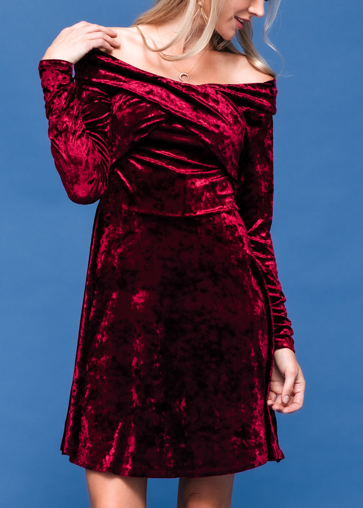 A stylish velvet off shoulder dress with a fitted bodice and heart-shaped neckline, perfect for evening wear.