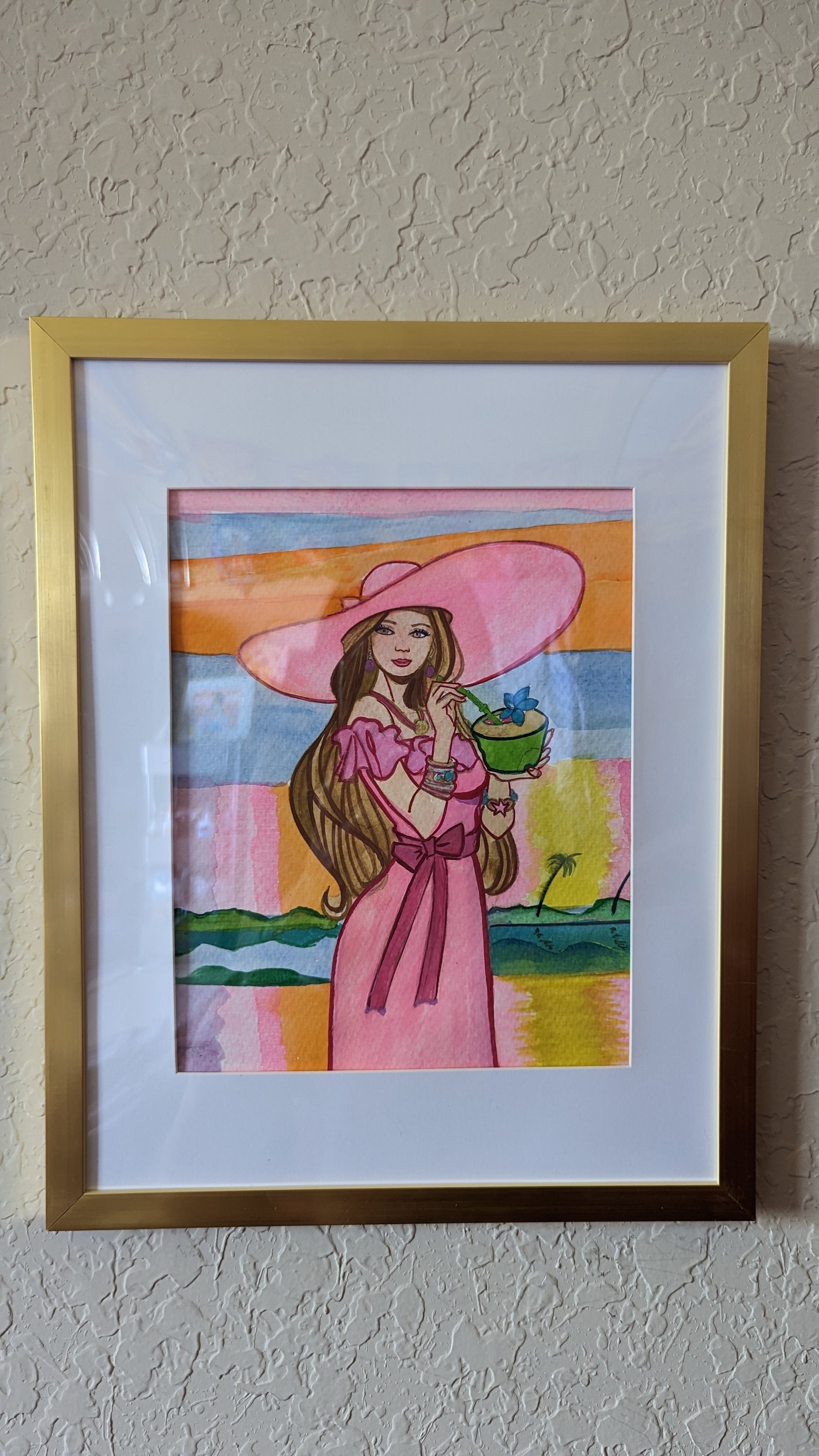 Original watercolor painting by Dominique featuring a light pink sunset over a Florida landscape, framed with plexiglass.