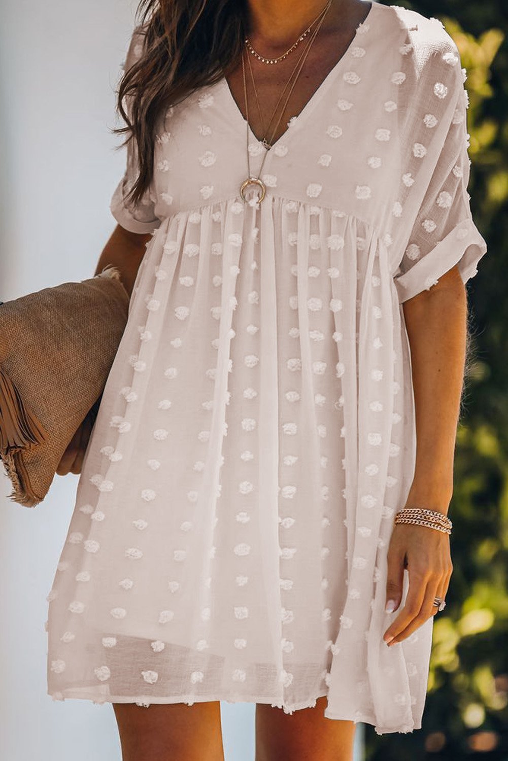 Woman wearing white polka dot dress.