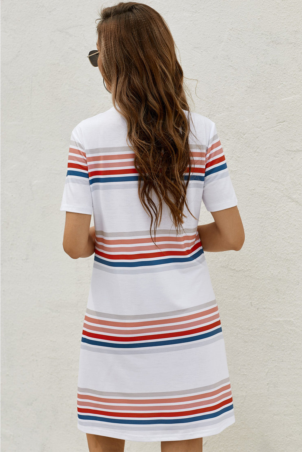 White striped print round neck short sleeve t-shirt mini dress displayed on a mannequin, showcasing its casual and chic style.