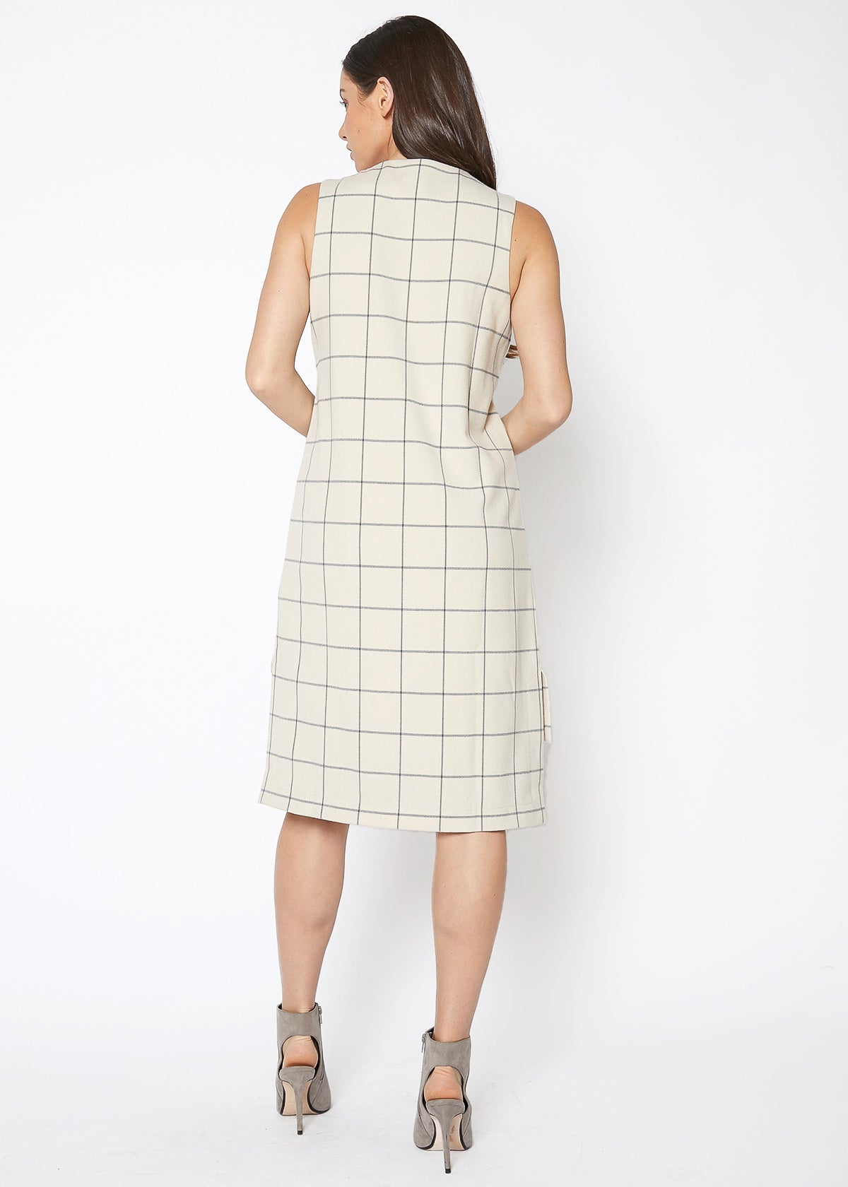 A stylish women's sleeveless dress featuring a high-low hemline and a window pane plaid pattern, perfect for professional and casual occasions.