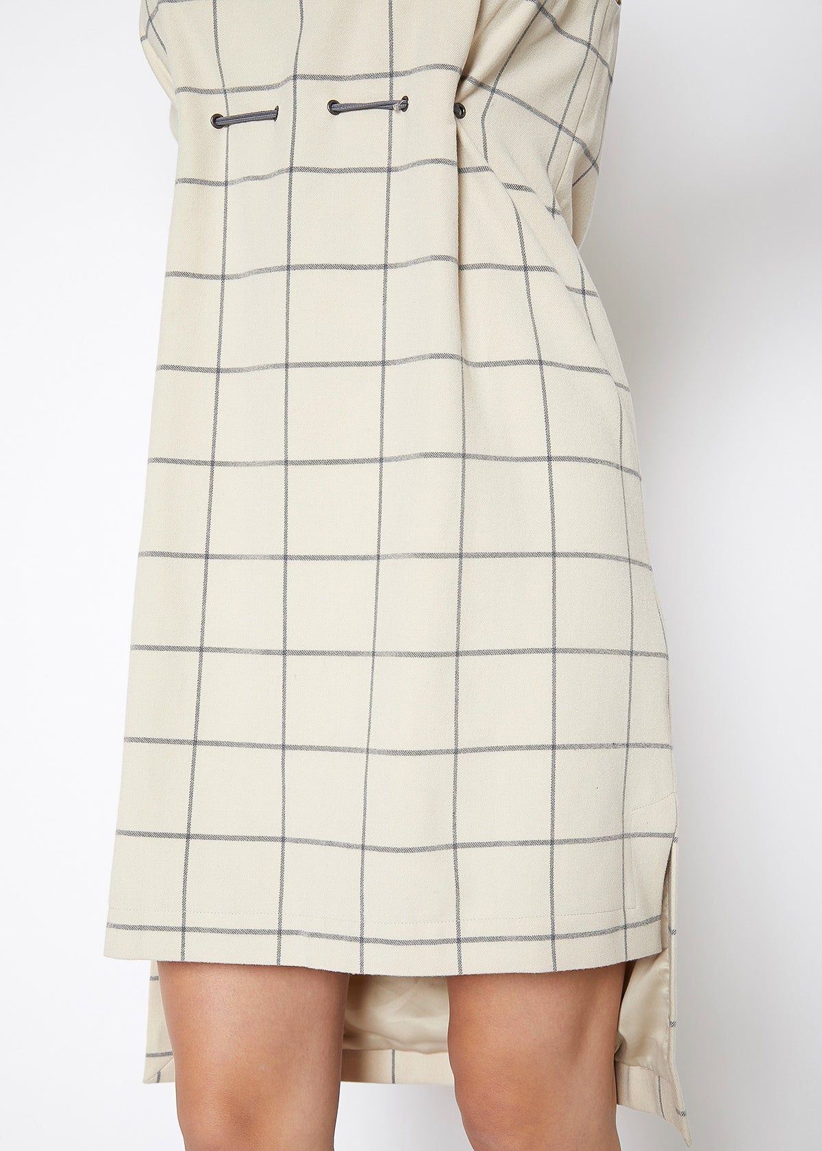 A stylish women's sleeveless dress featuring a high-low hemline and a window pane plaid pattern, perfect for professional and casual occasions.