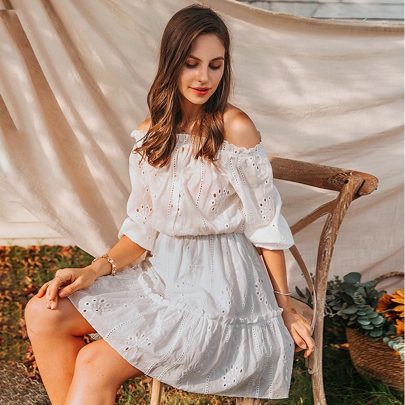 A stylish women sexy white off-shoulder dress with ruffles, made of cotton, perfect for summer occasions.