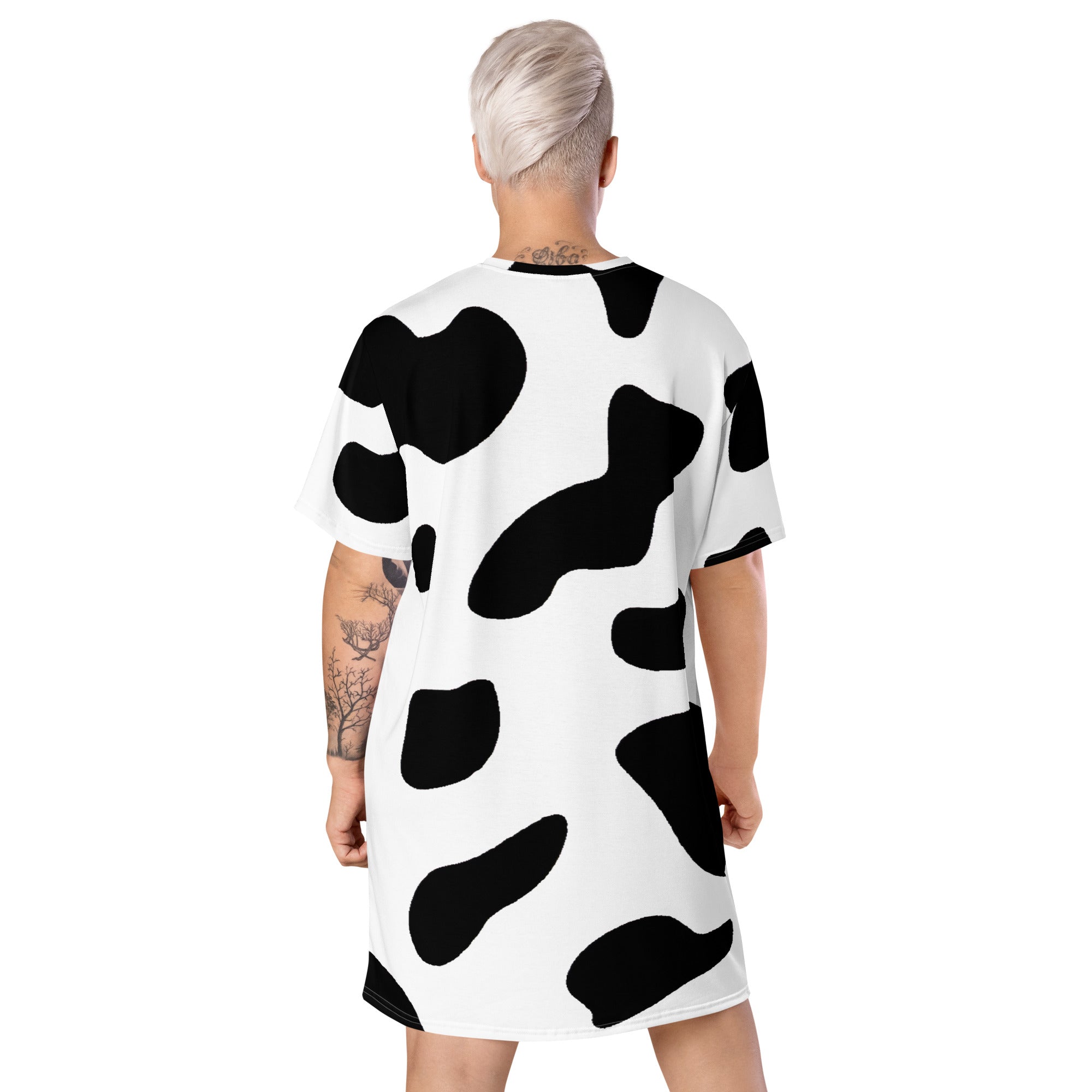 Womens Graphic T-shirt Dress featuring a trendy black and white cow print, showcasing its oversized fit and stylish design.