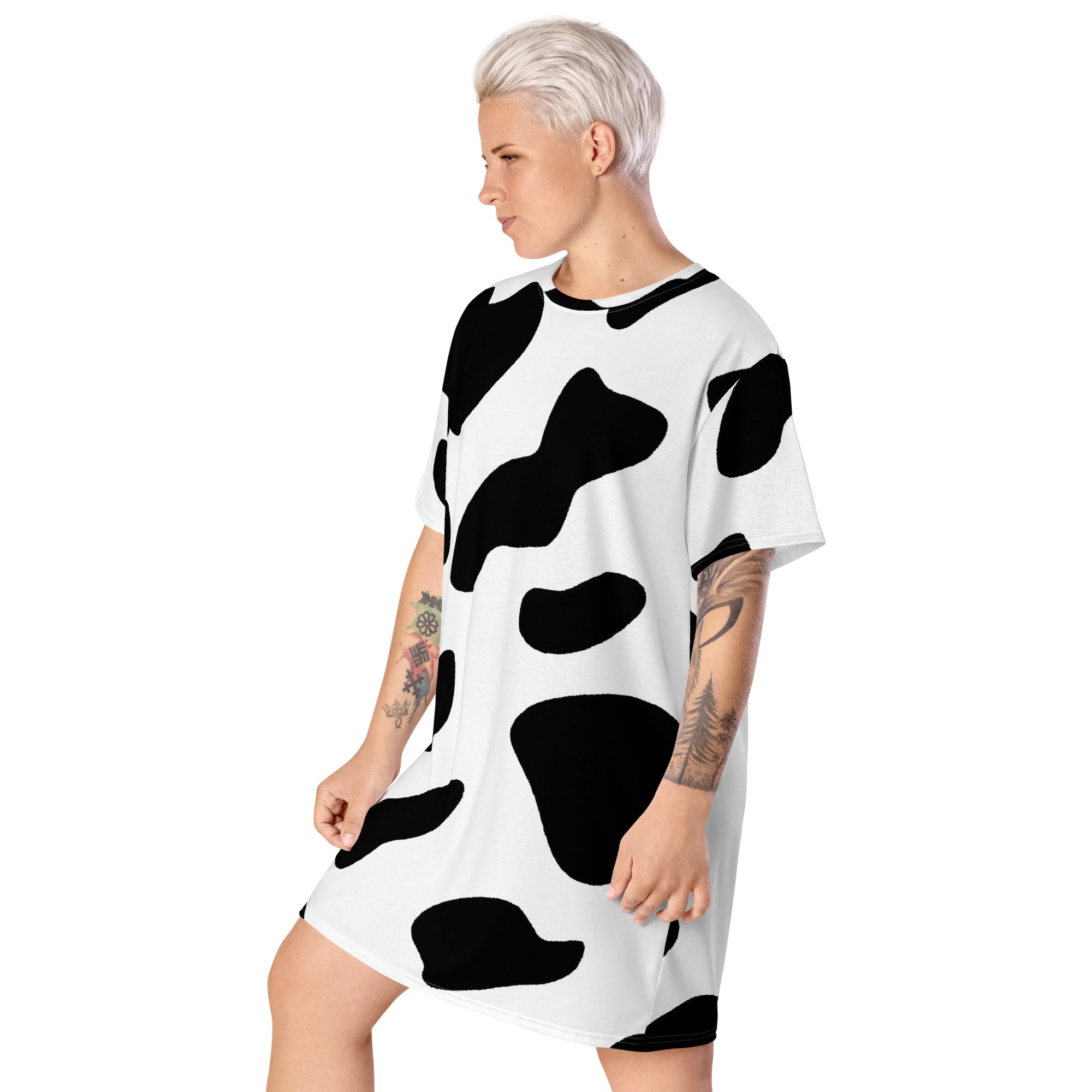 Womens Graphic T-shirt Dress featuring a trendy black and white cow print, showcasing its oversized fit and stylish design.