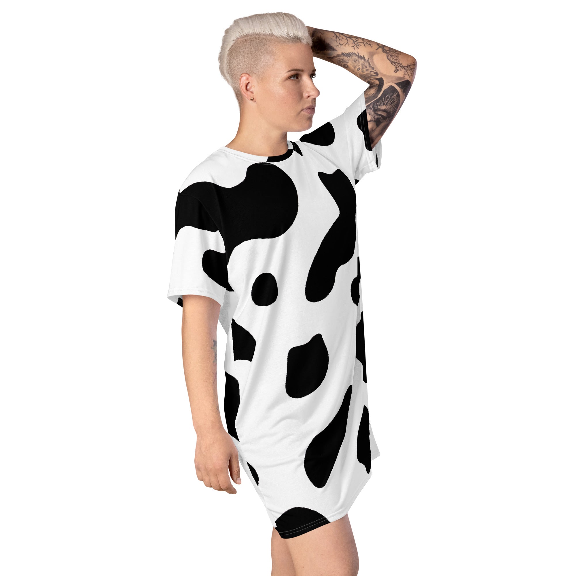 Womens Graphic T-shirt Dress featuring a trendy black and white cow print, showcasing its oversized fit and stylish design.