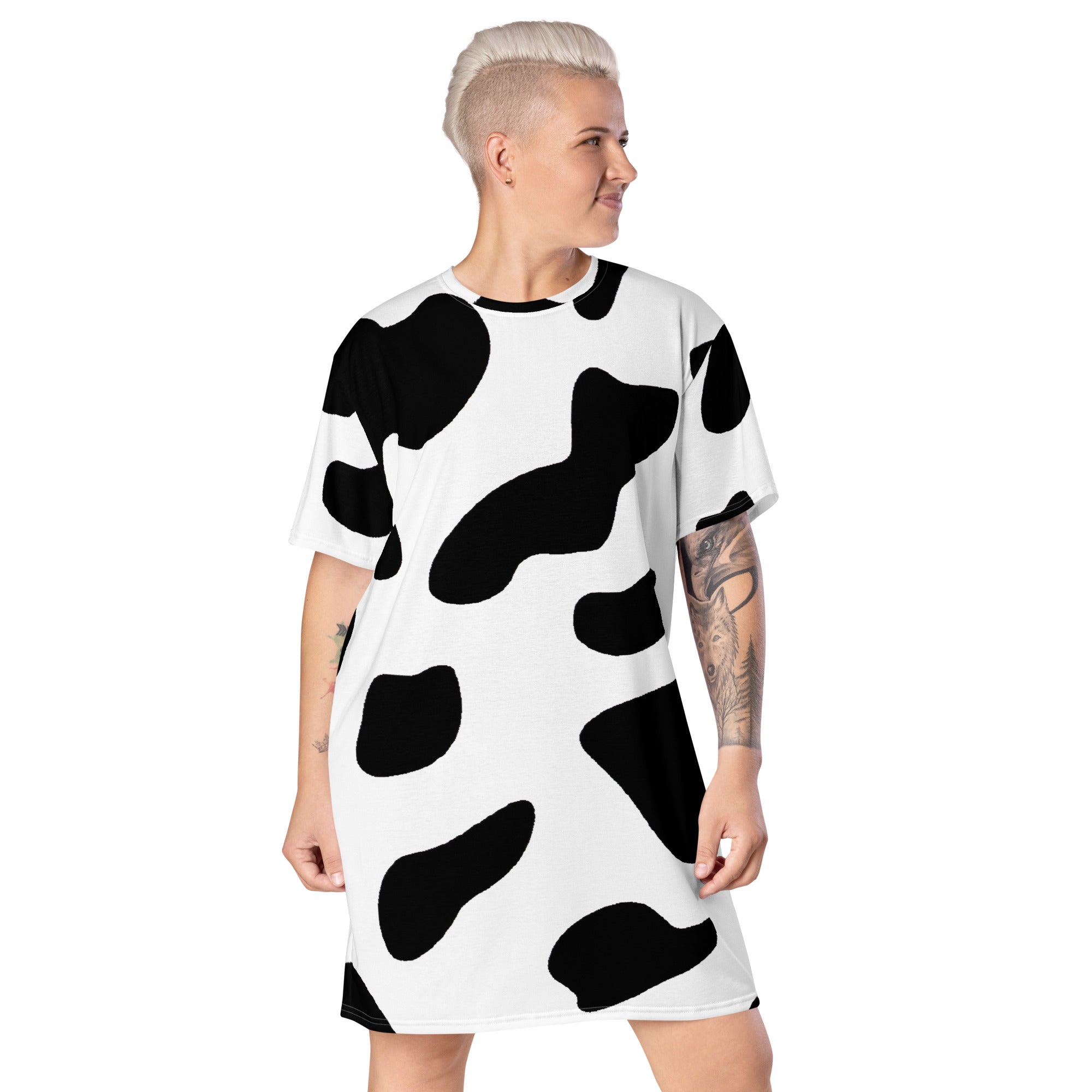 Womens Graphic T-shirt Dress featuring a trendy black and white cow print, showcasing its oversized fit and stylish design.