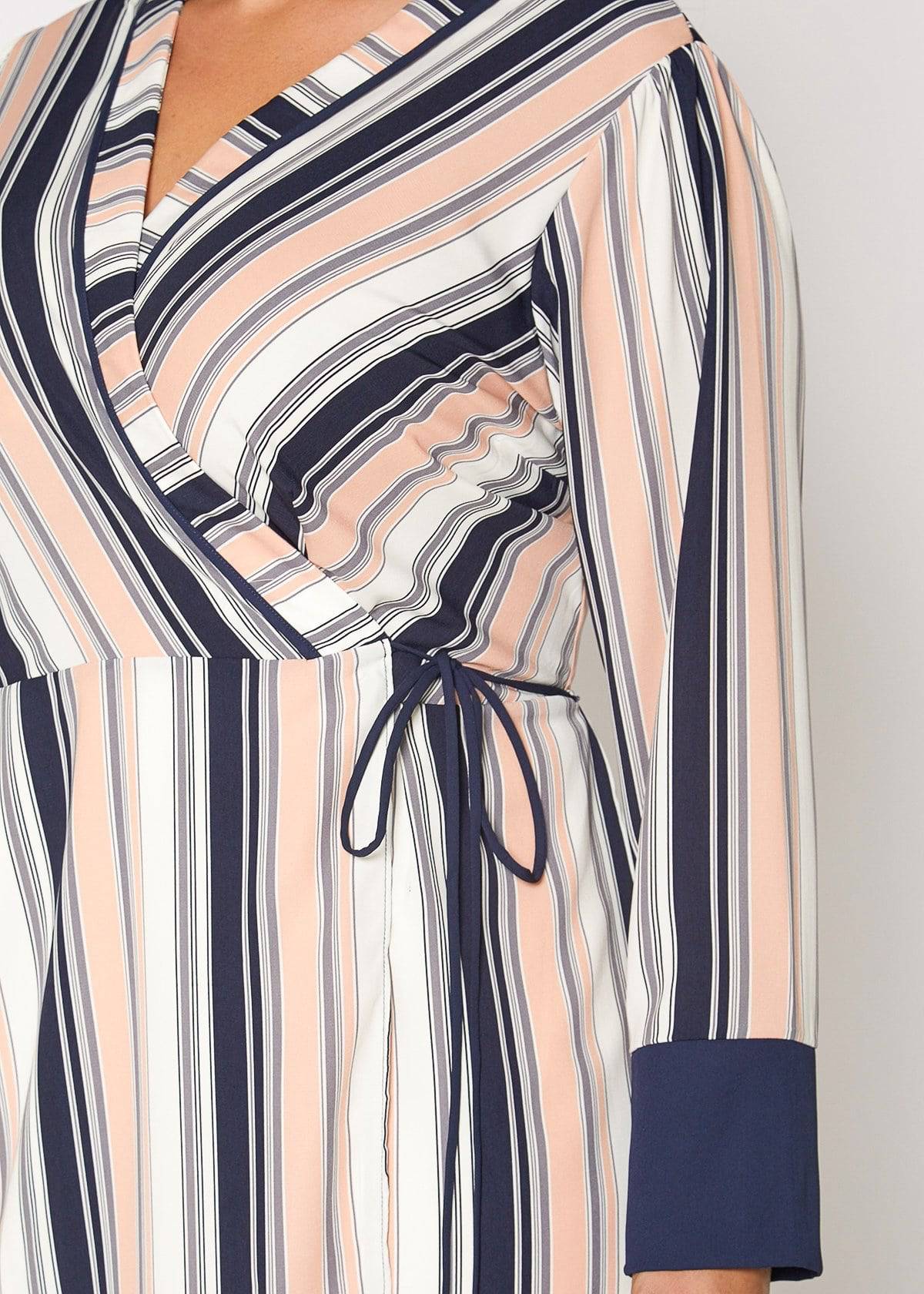 Women's multi-stripe printed wrap dress with cuff binding and waist tie detail, showcasing long sleeves and vibrant colors.