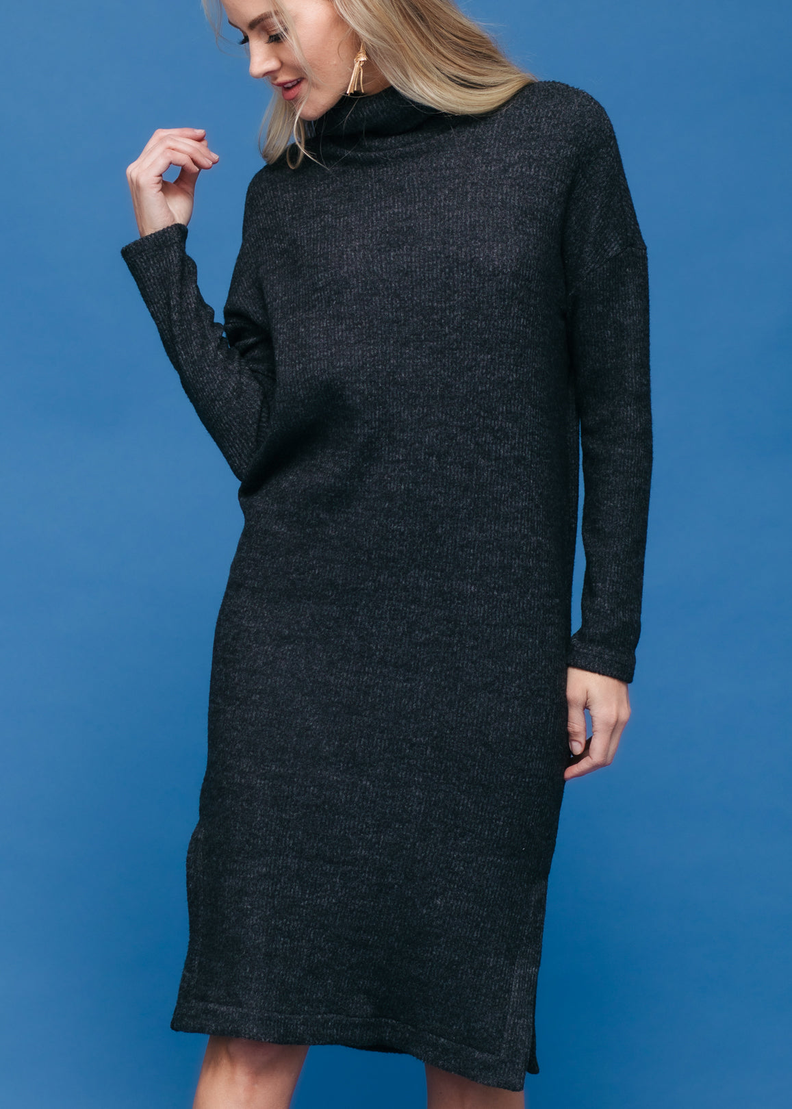 A stylish Women's Turtle Neck Midi Sweater Dress featuring long sleeves, a knee-length cut, and a side split, made from a soft fabric blend.