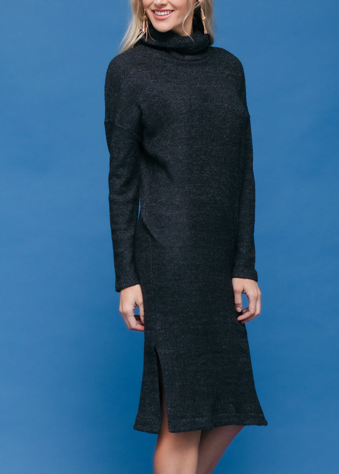 A stylish Women's Turtle Neck Midi Sweater Dress featuring long sleeves, a knee-length cut, and a side split, made from a soft fabric blend.