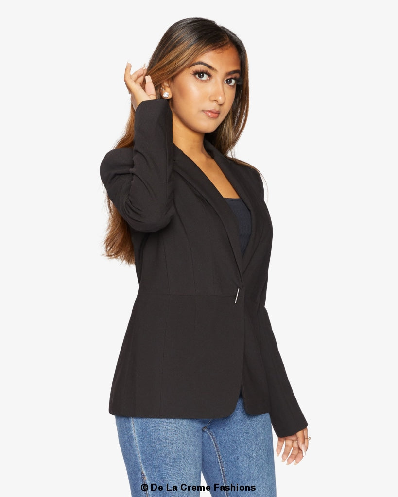 A stylish black casual blazer displayed on a mannequin, showcasing its relaxed fit and versatile design for various occasions.