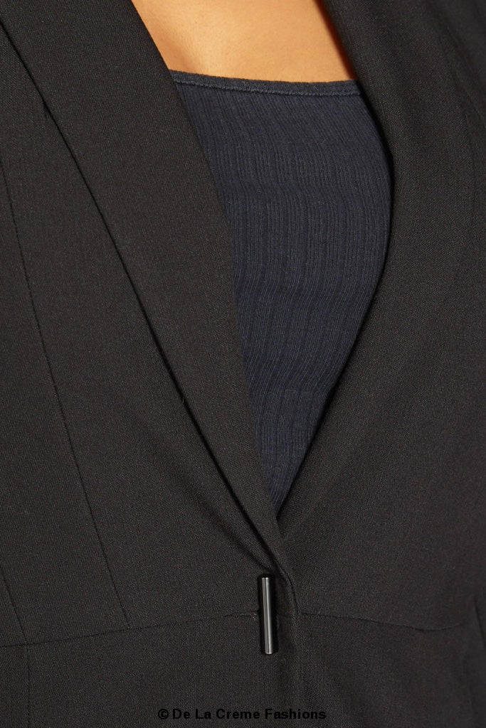 A stylish black casual blazer displayed on a mannequin, showcasing its relaxed fit and versatile design for various occasions.