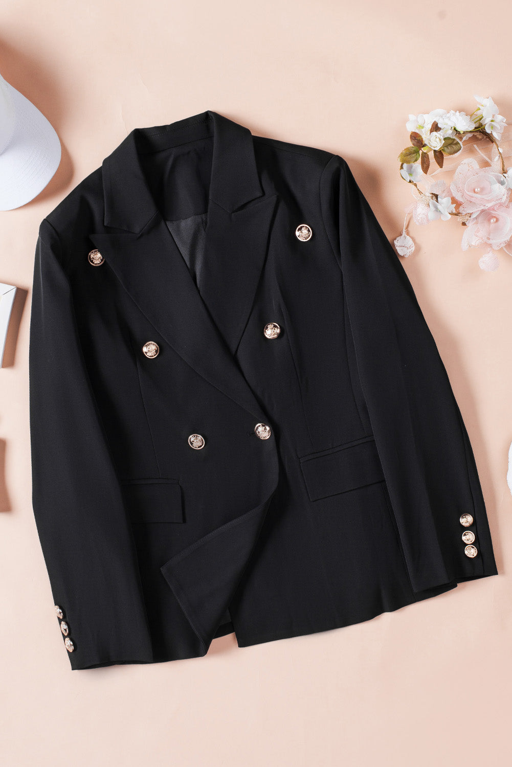 A stylish black double-breasted lapel blazer for women, featuring a notched collar and functional flap pockets.