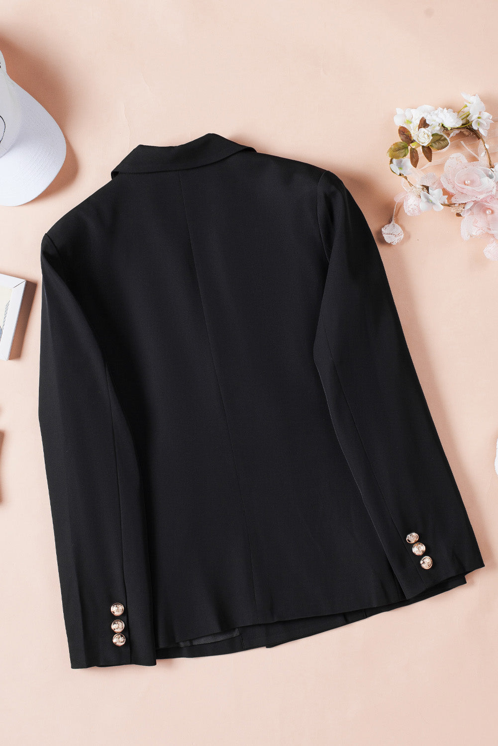 A stylish black double-breasted lapel blazer for women, featuring a notched collar and functional flap pockets.