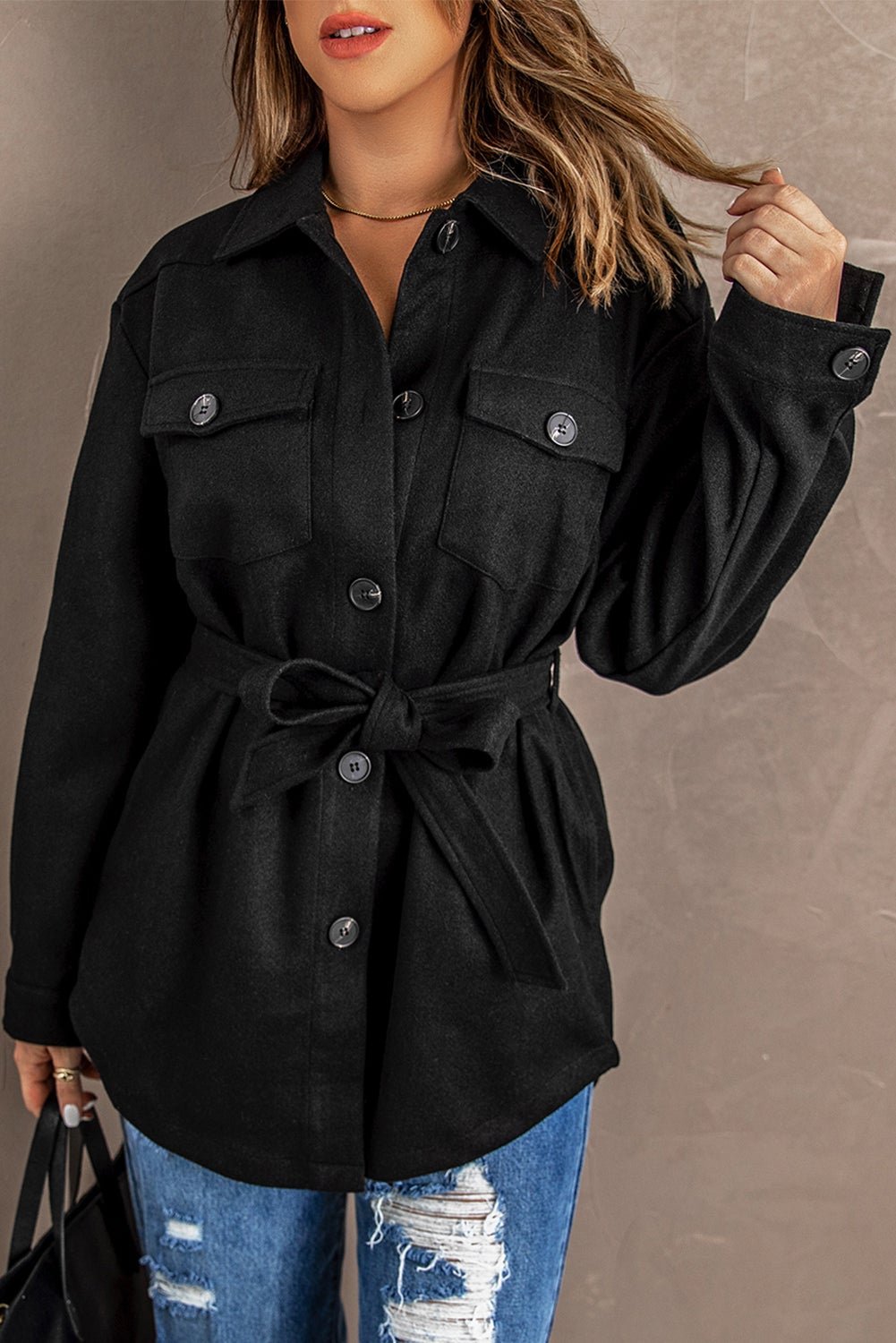 A stylish Black Lapel Button-Down Coat featuring full sleeves, chic chest pockets, and a turn-down collar, perfect for winter wear.