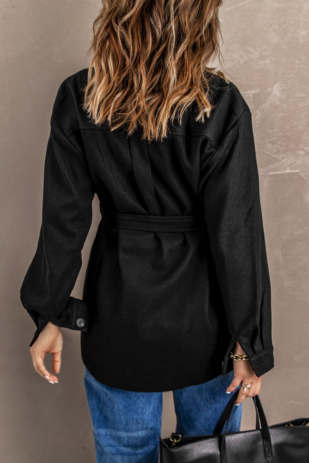 A stylish Black Lapel Button-Down Coat featuring full sleeves, chic chest pockets, and a turn-down collar, perfect for winter wear.