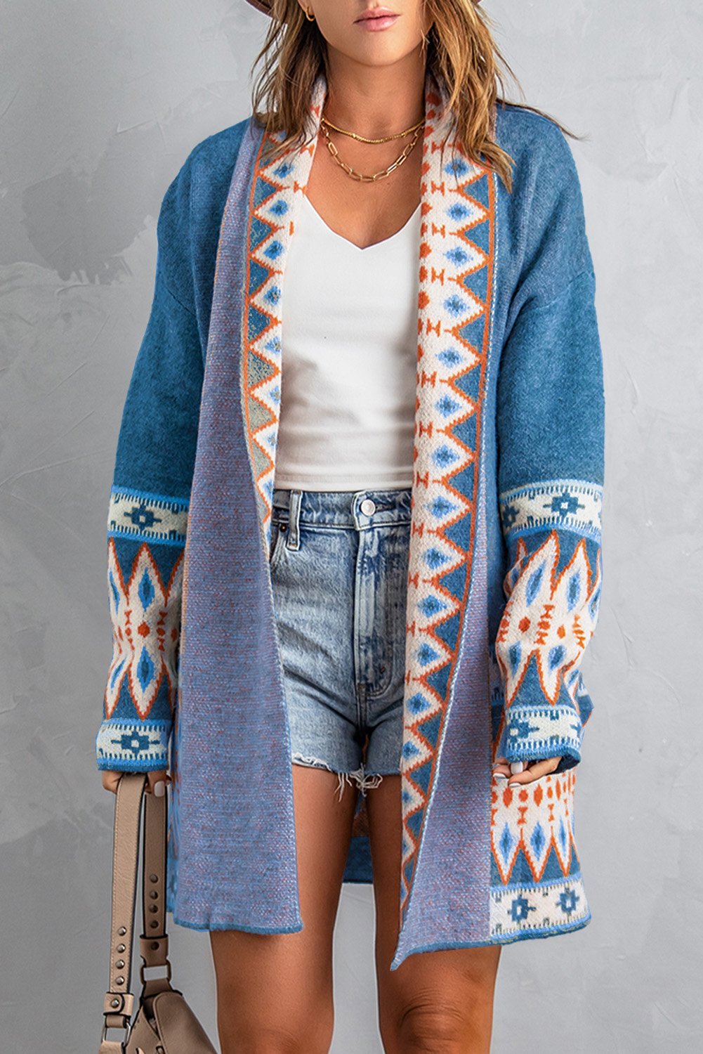 A stylish blue cardigan featuring a unique Aztec print design, open front, and full sleeves, perfect for casual wear.