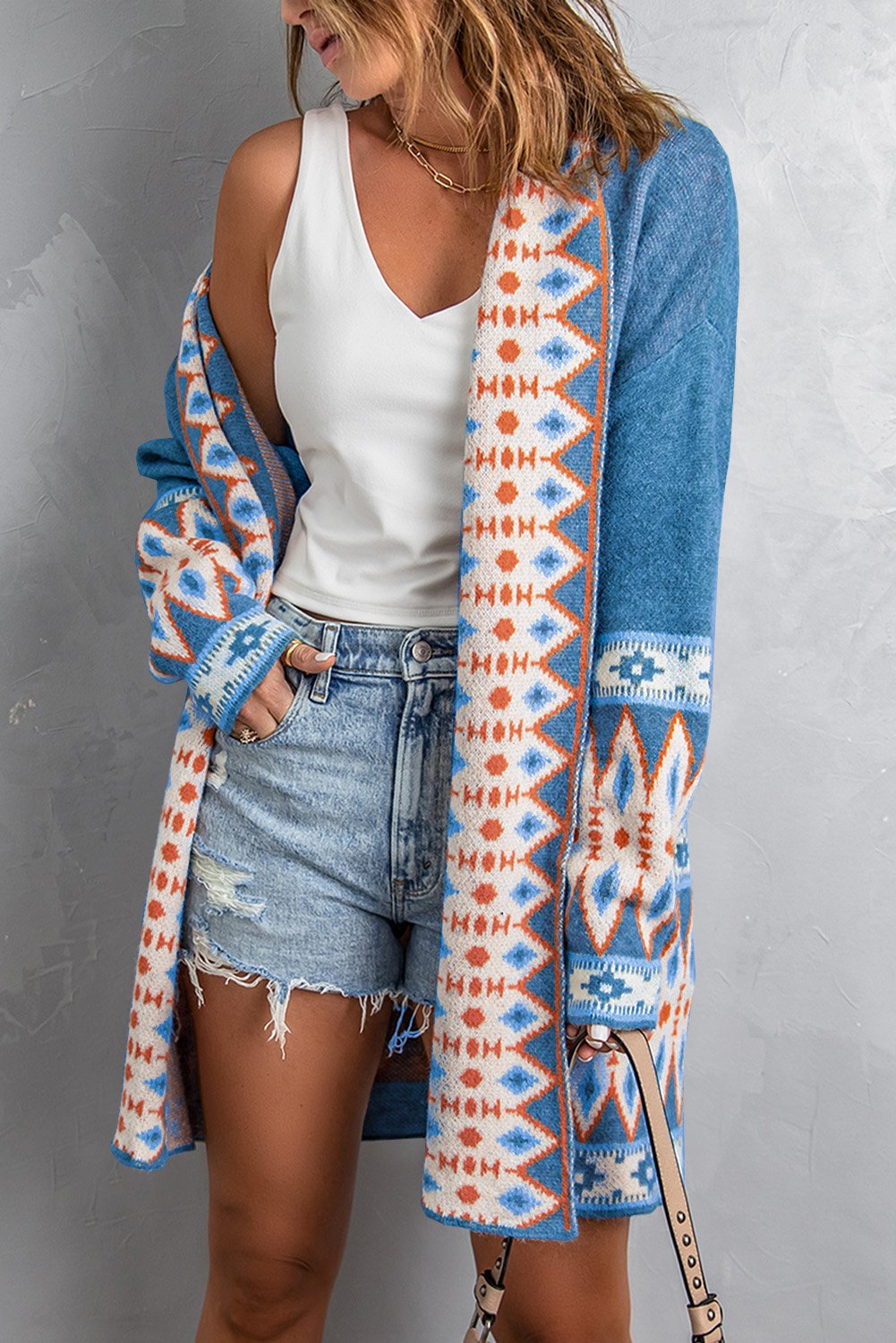 A stylish blue cardigan featuring a unique Aztec print design, open front, and full sleeves, perfect for casual wear.