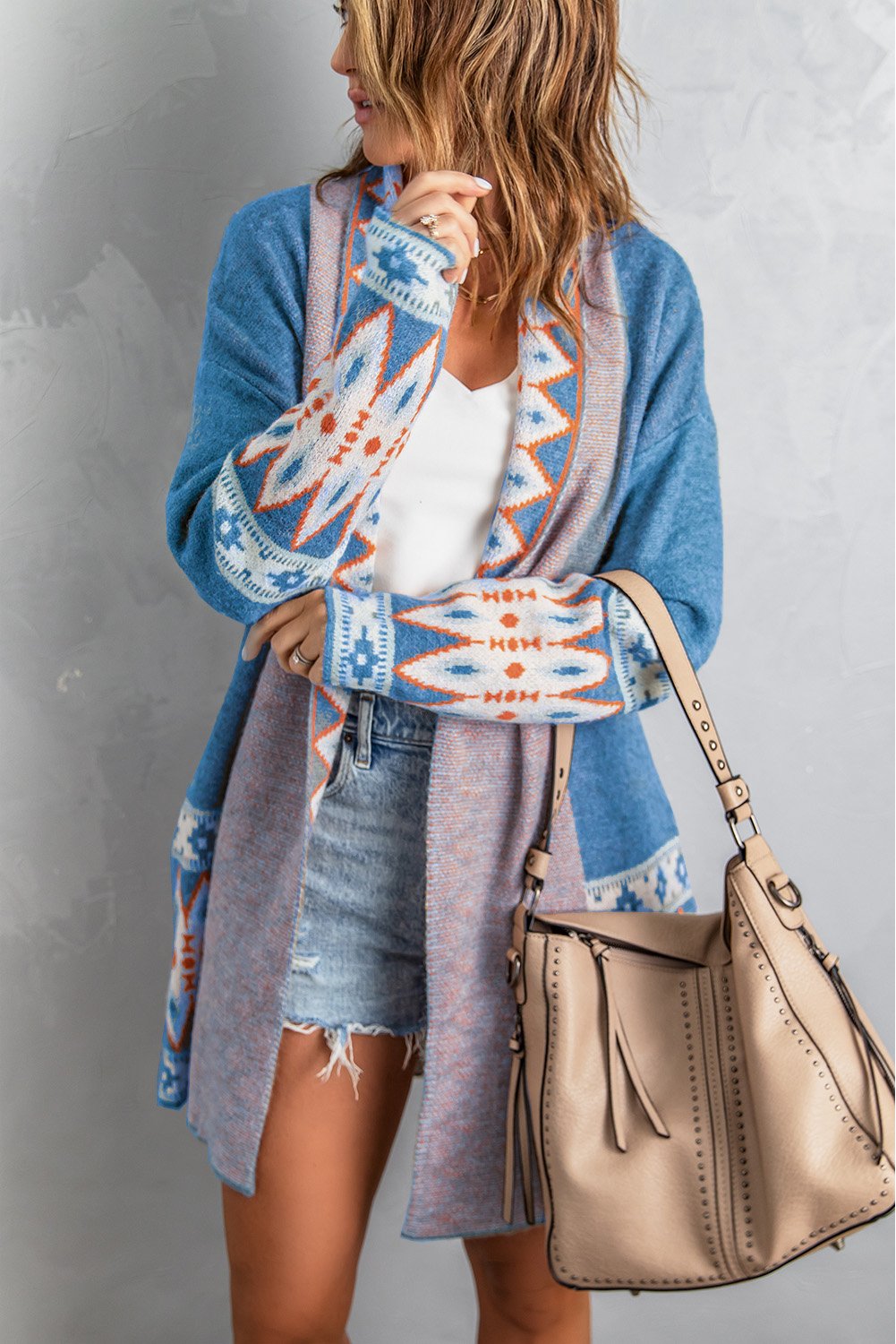 A stylish blue cardigan featuring a unique Aztec print design, open front, and full sleeves, perfect for casual wear.