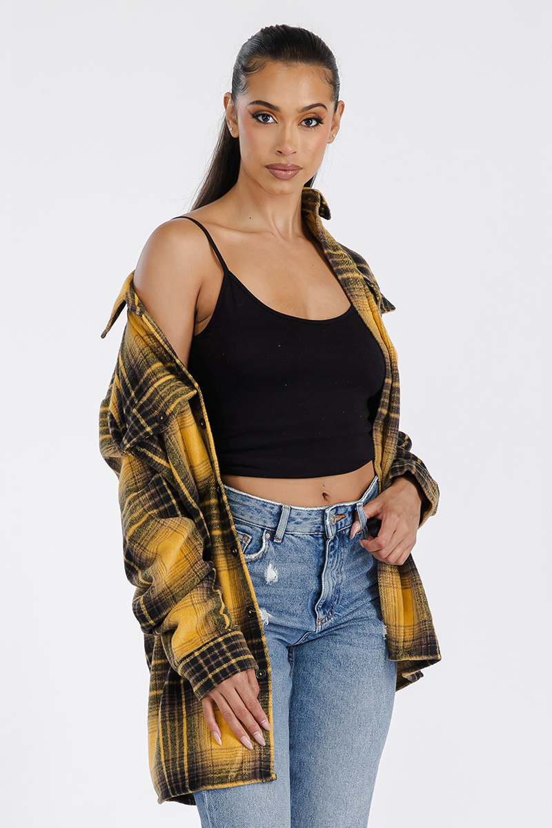 A stylish oversized flannel shacket for women, featuring a button closure and chest pockets, made from soft brushed fabric.