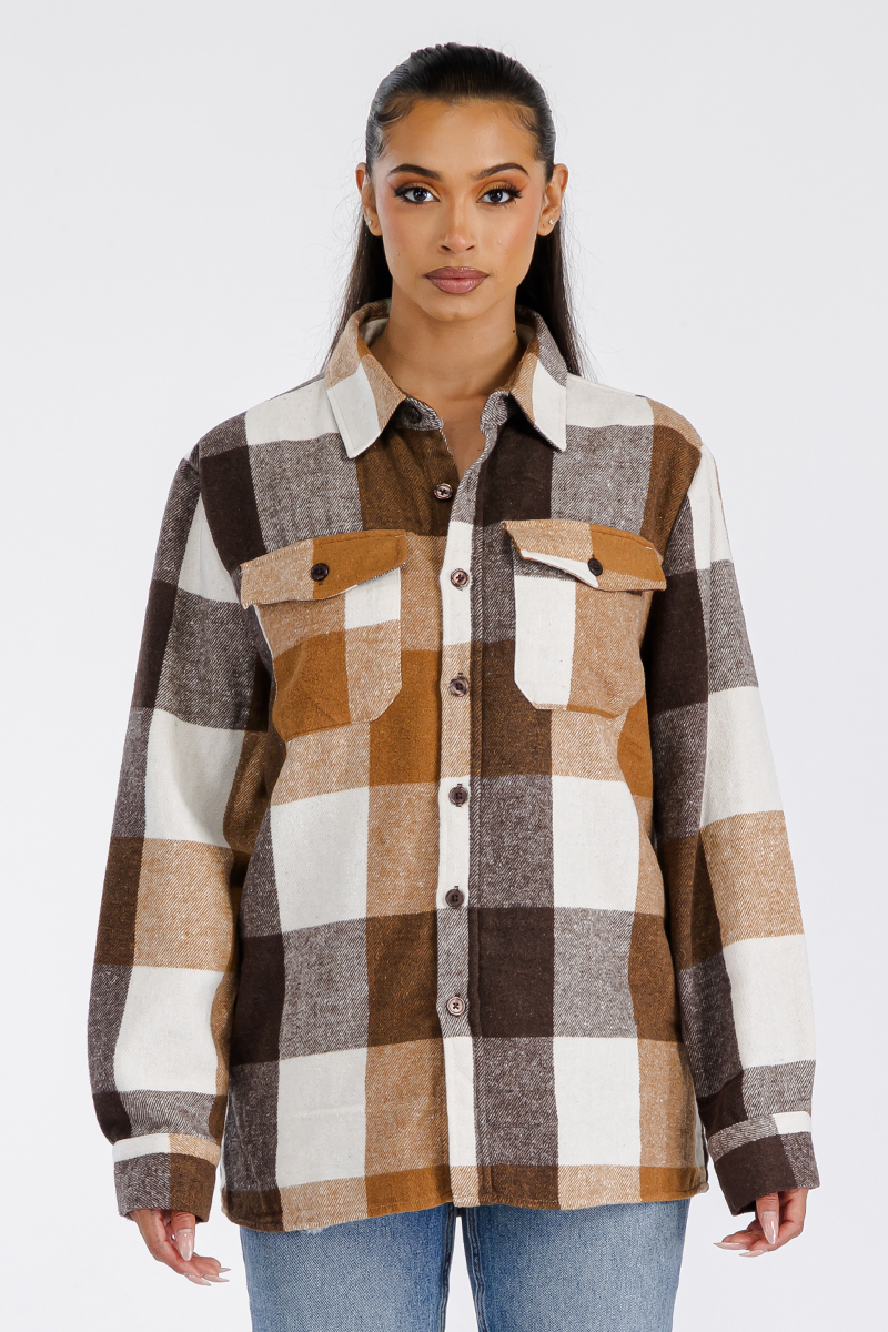 A stylish oversized flannel shacket for women, featuring a button closure and chest pockets, made from soft brushed fabric.