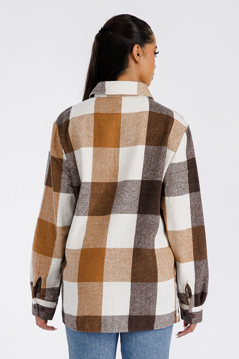 A stylish oversized flannel shacket for women, featuring a button closure and chest pockets, made from soft brushed fabric.