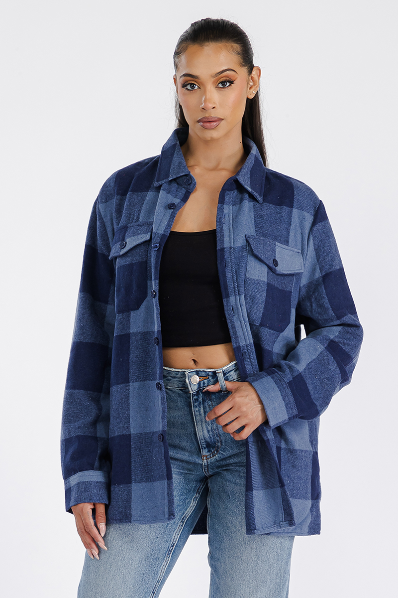 A stylish woman wearing a Boyfriend Oversized Soft Flannel Shacket, showcasing its soft fabric, button closure, and chest pockets.