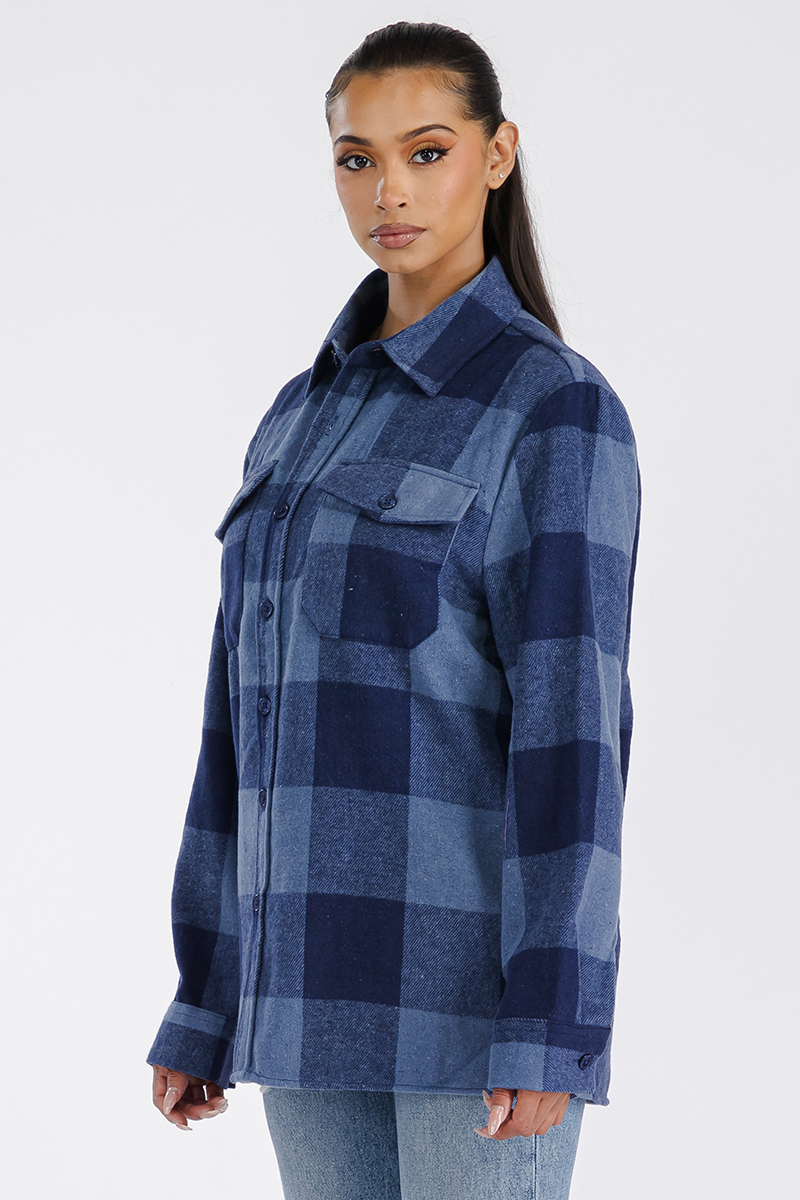 A stylish woman wearing a Boyfriend Oversized Soft Flannel Shacket, showcasing its soft fabric, button closure, and chest pockets.