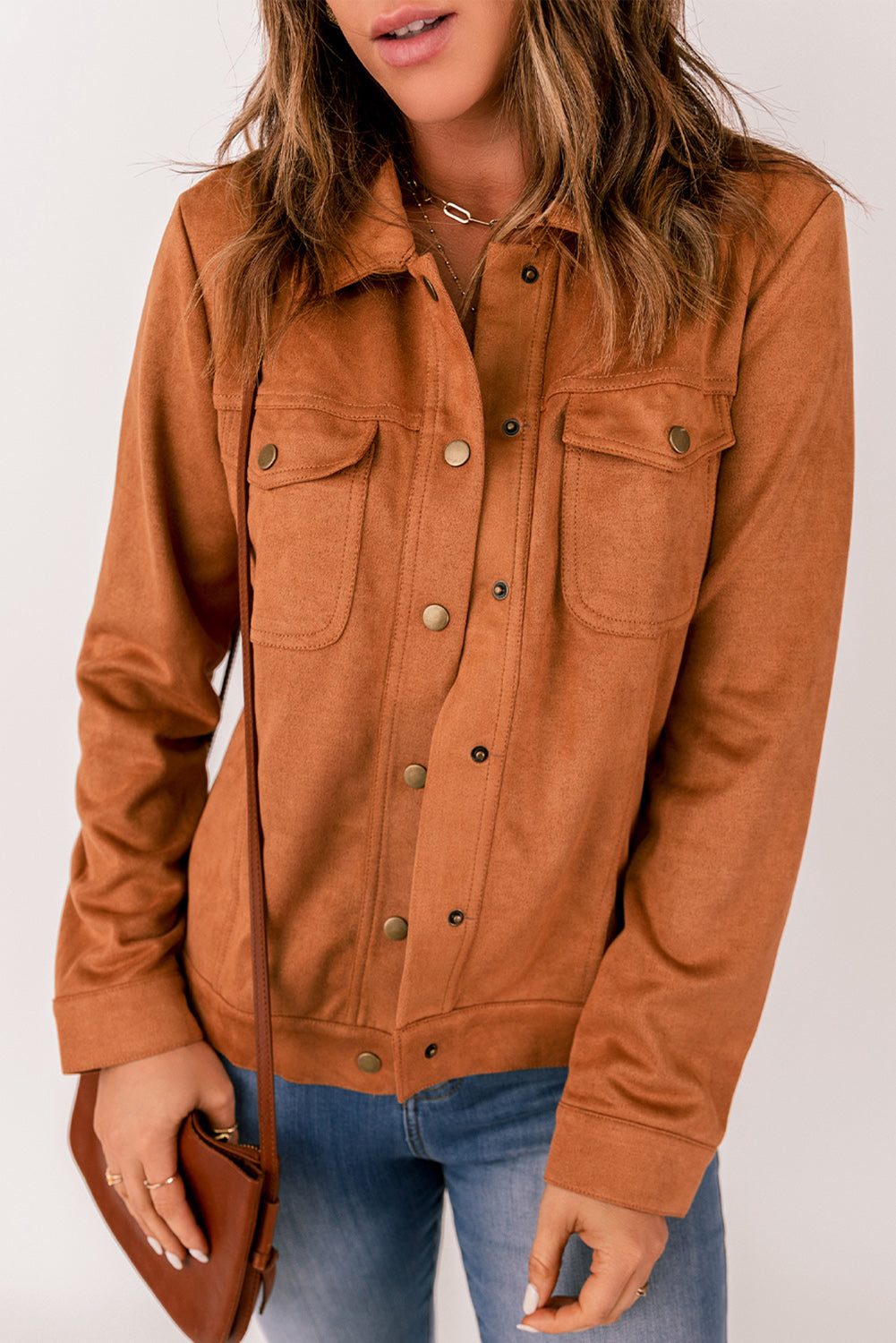 Brown suede jacket with flap pockets and snap button closure, perfect for winter wear.