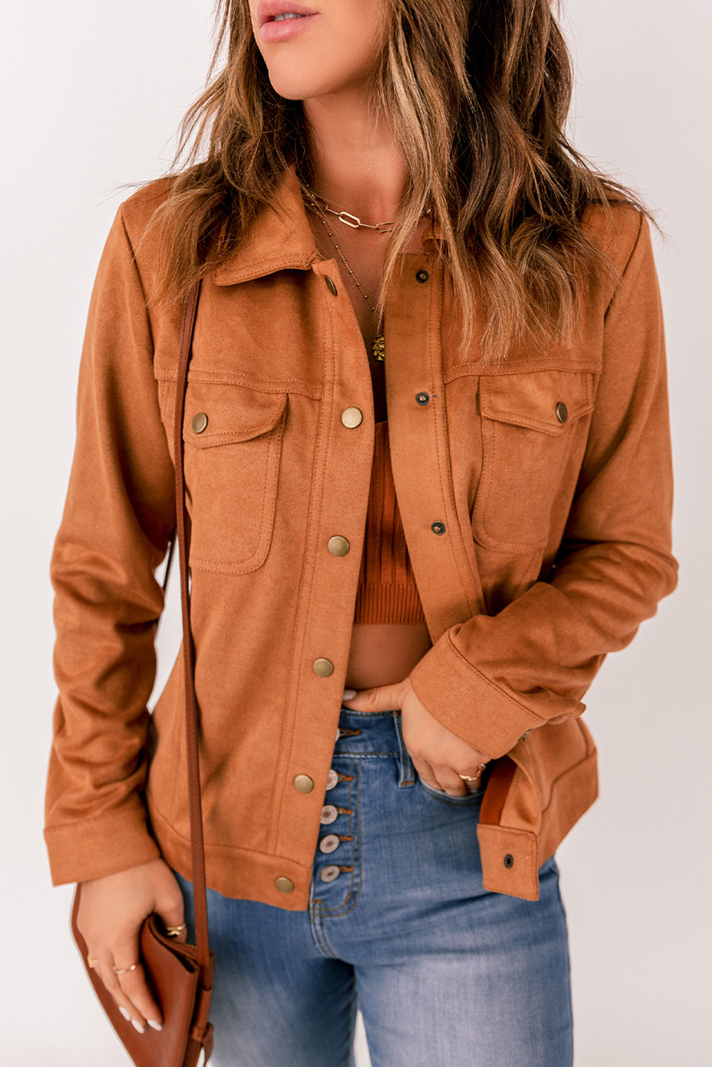 Brown suede jacket with flap pockets and snap button closure, perfect for winter wear.