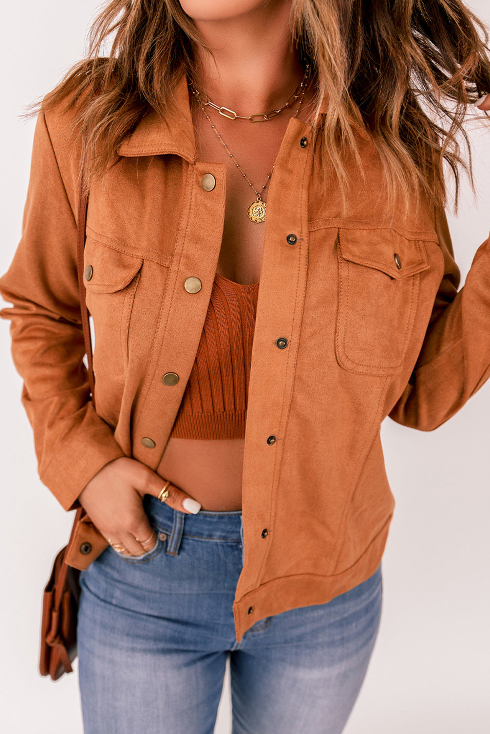 Brown suede jacket with flap pockets and snap button closure, perfect for winter wear.