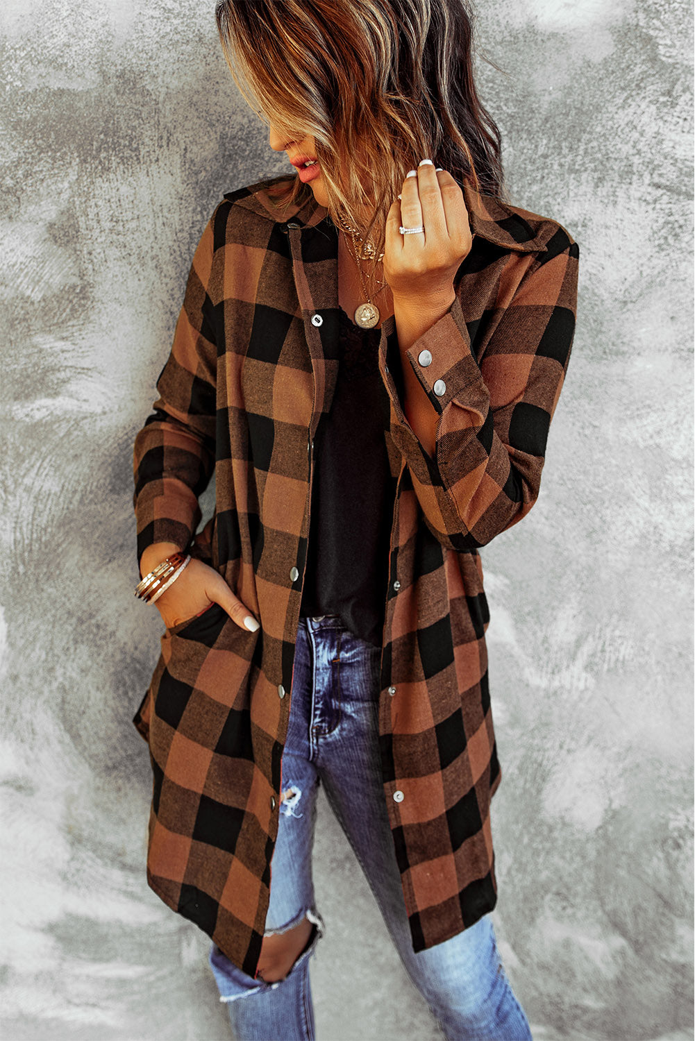 Brown plaid shacket with long sleeves and turn-down collar, perfect for winter layering.