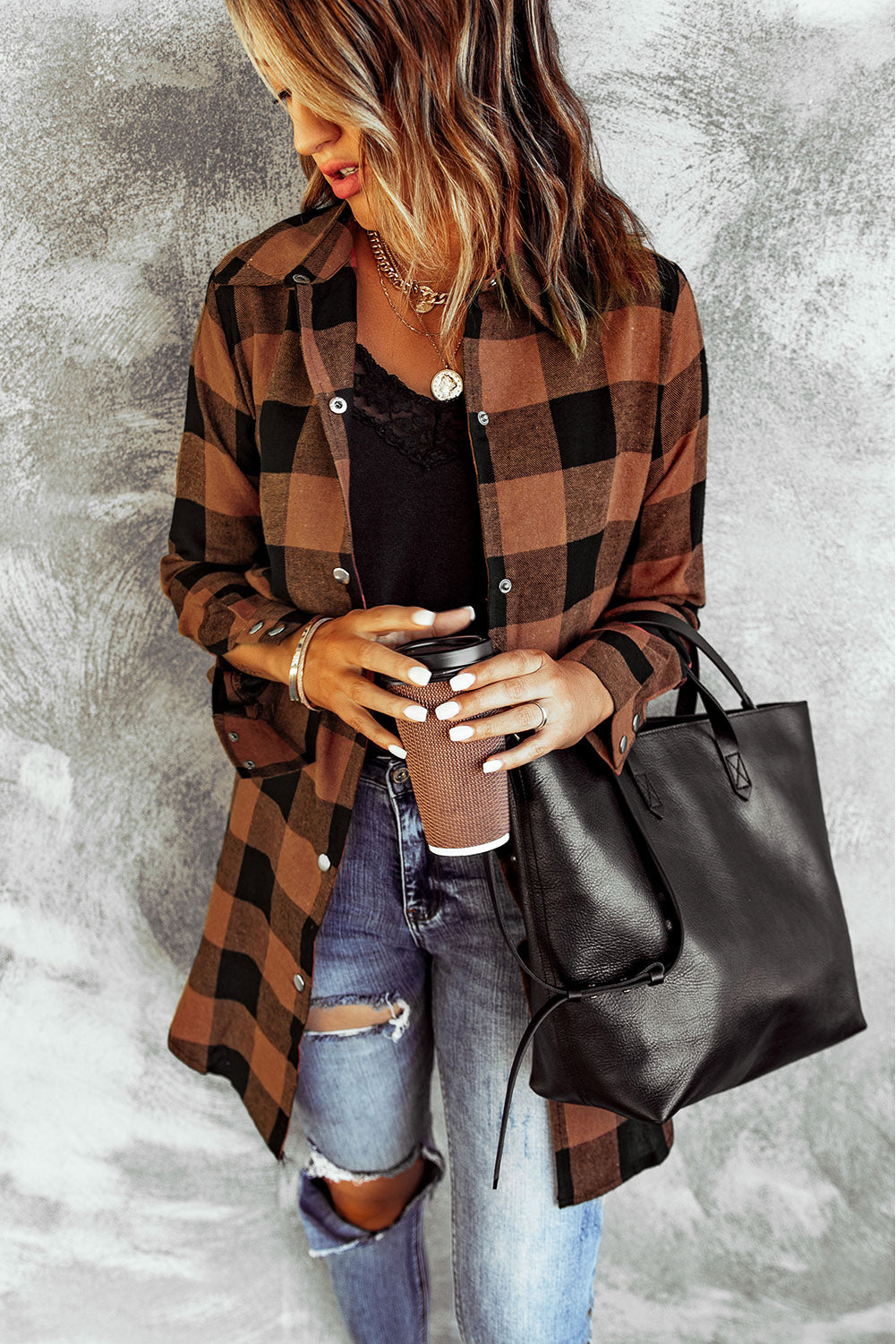 Brown plaid shacket with long sleeves and turn-down collar, perfect for winter layering.