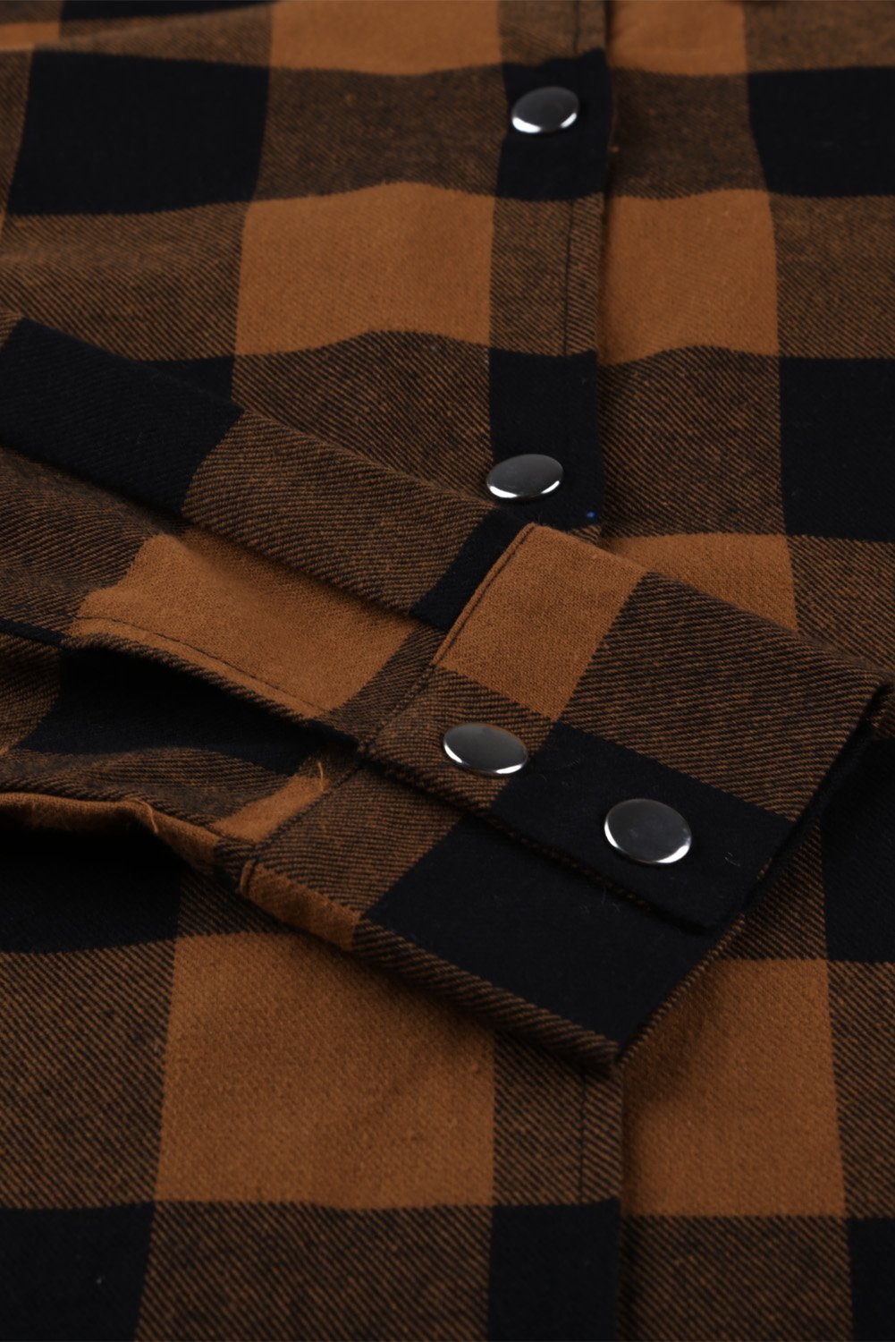 Brown plaid shacket with long sleeves and turn-down collar, perfect for winter layering.