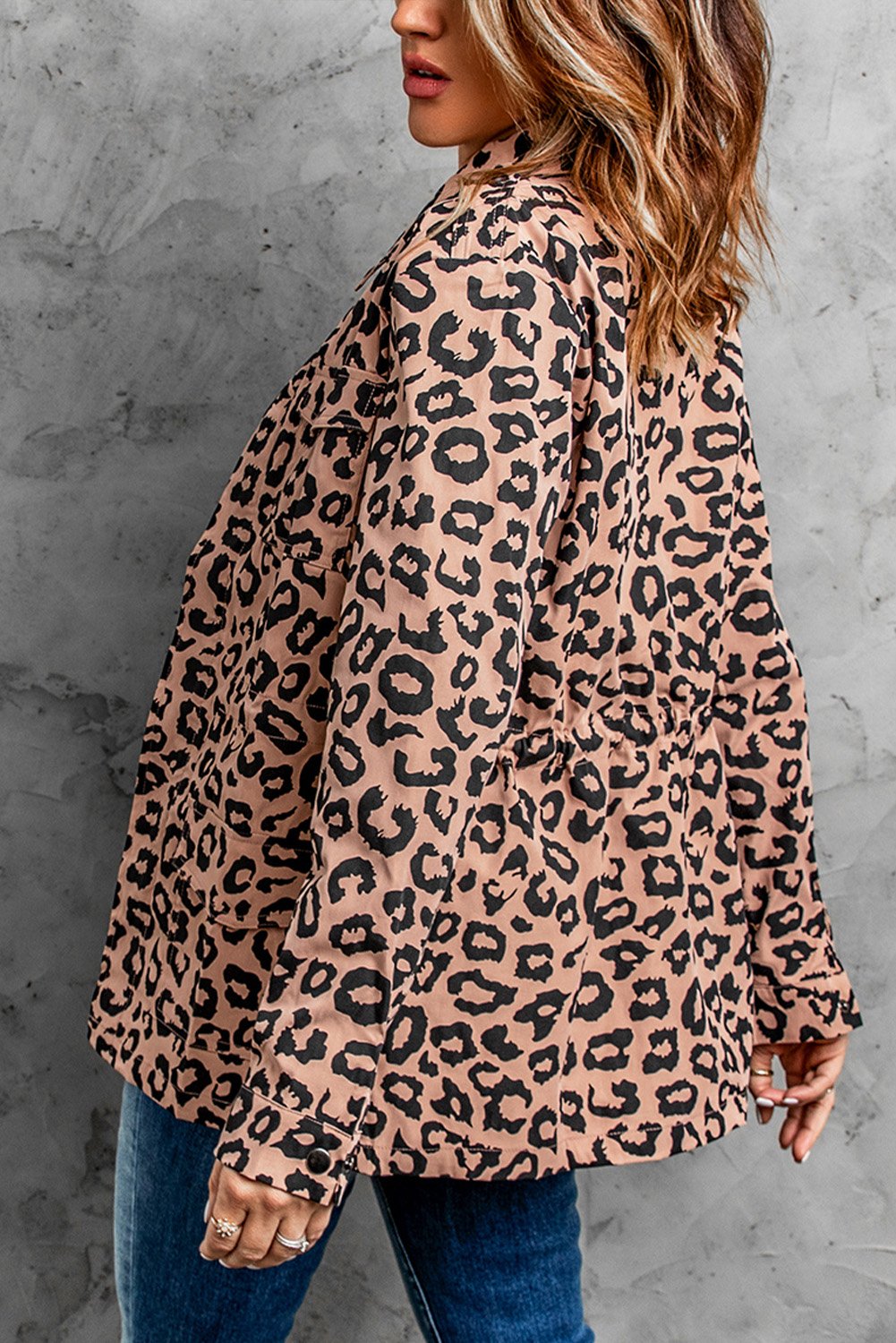 Brown leopard print coat with zipper closure and drawstring waist, featuring long sleeves and a lapel collar.