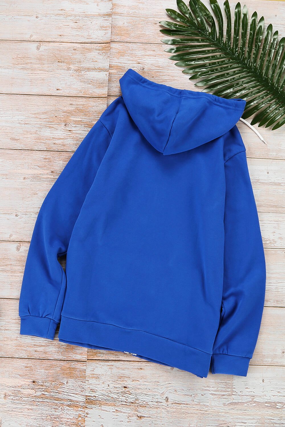 Casual blue zip-up hoodie jacket with white metallic zipper and drawcords, showcasing a stylish and comfortable design for various occasions.