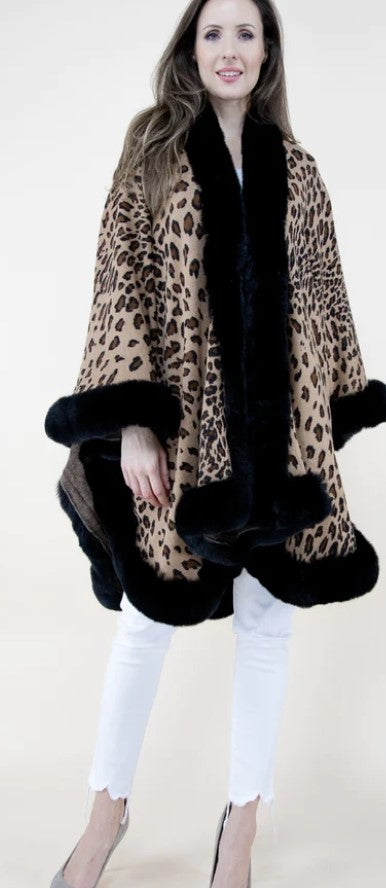 Cheetah print ruana with faux fur trim, showcasing its stylish design and soft texture.