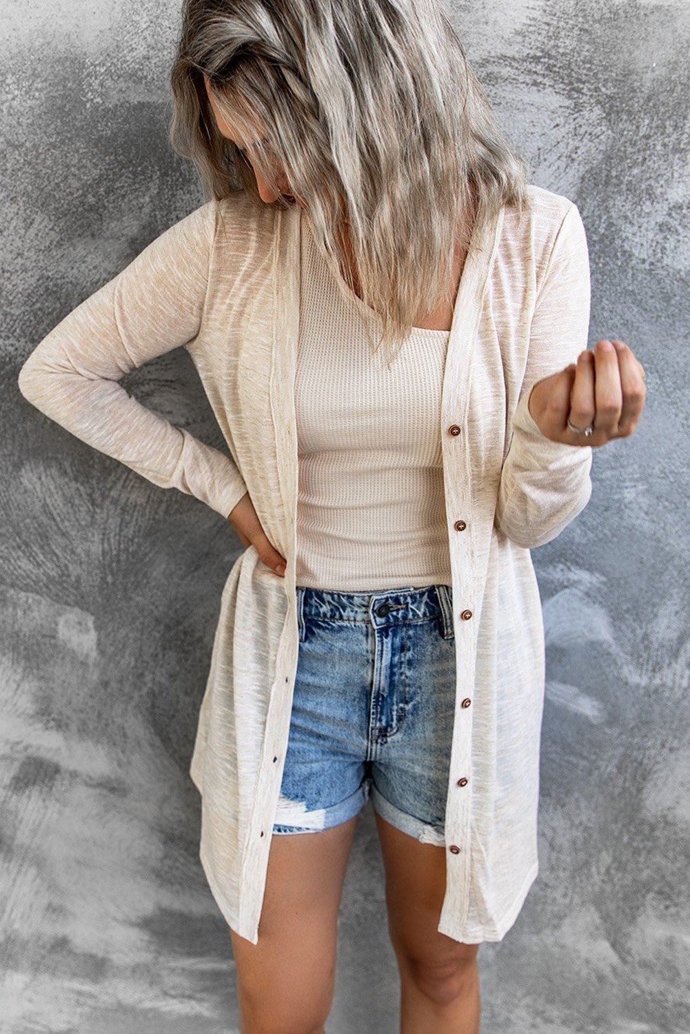 A stylish Comfy Beige Cardigan featuring an open front design and button closure, perfect for layering in fall and spring.