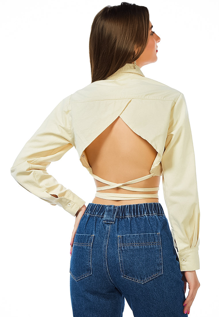 Cut Out Back Long Sleeve Jacket featuring a backless design with self-tie strings and long cuffed sleeves, made from 100% cotton.