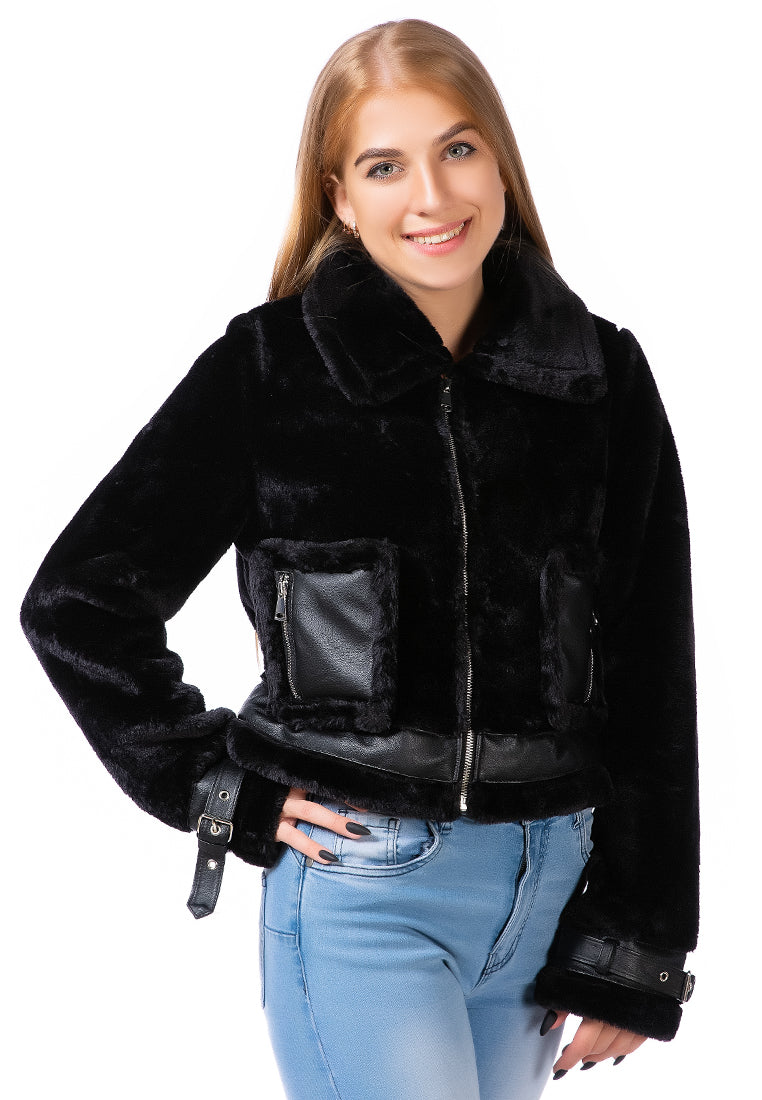 A stylish faux fur collared jacket featuring belted cuffs and patch pockets, perfect for winter fashion.