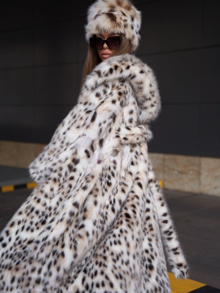 Elegant women's faux fur X-long coat in white with a hood, featuring luxurious lynx design and covered button closure.