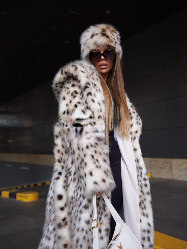 Elegant women's faux fur X-long coat in white with a hood, featuring luxurious lynx design and covered button closure.