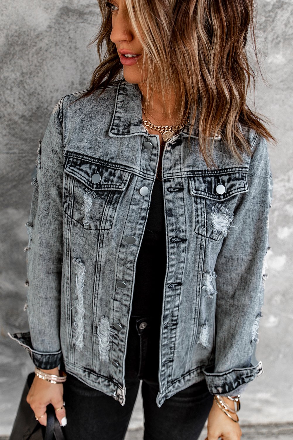 Gray distressed jean jacket featuring a turn-down collar and button closure, perfect for casual winter wear.