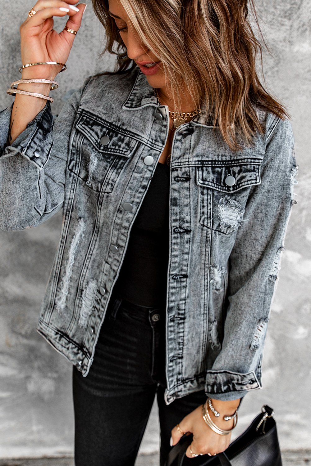 Gray distressed jean jacket featuring a turn-down collar and button closure, perfect for casual winter wear.