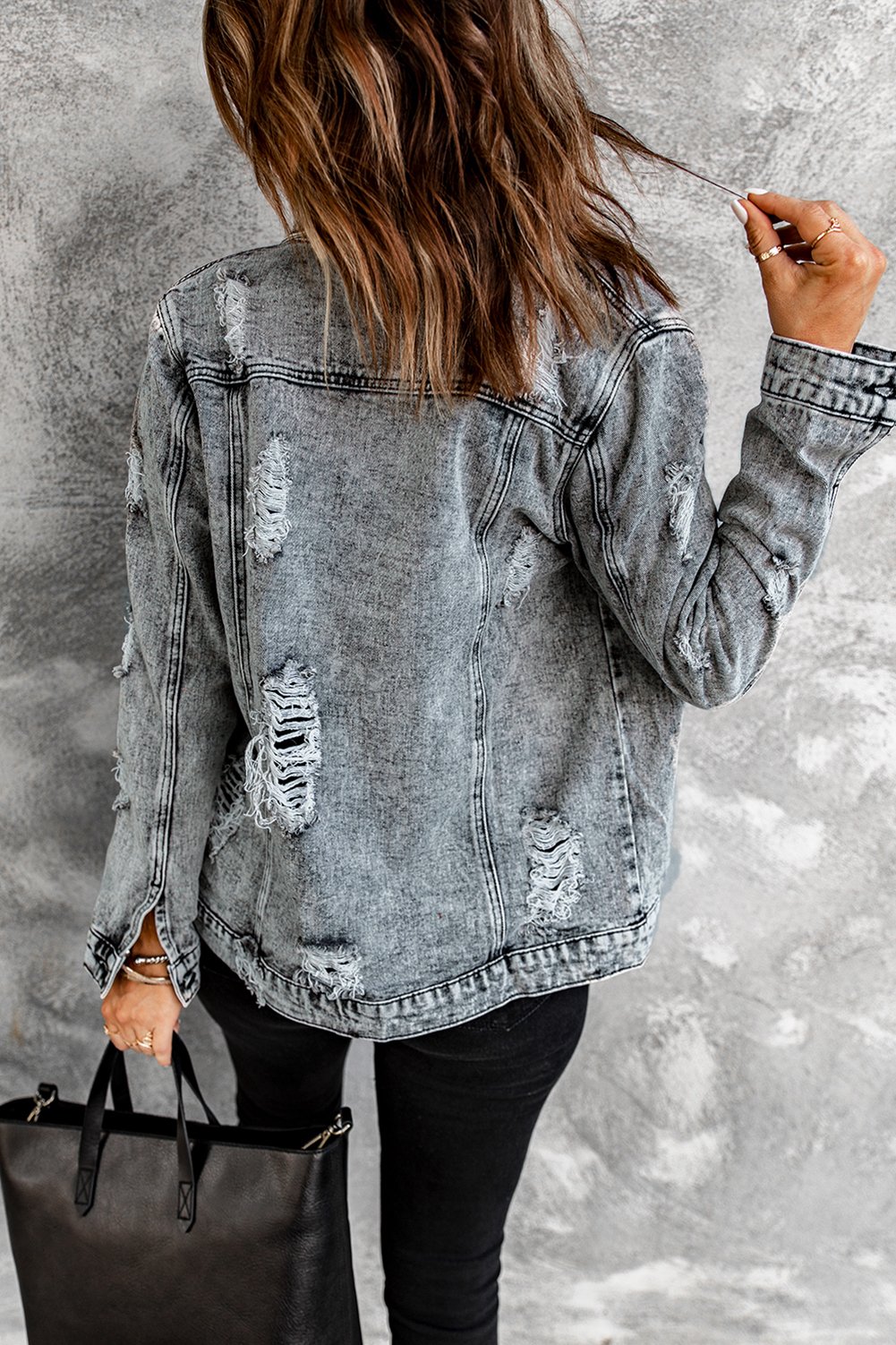 Gray distressed jean jacket featuring a turn-down collar and button closure, perfect for casual winter wear.