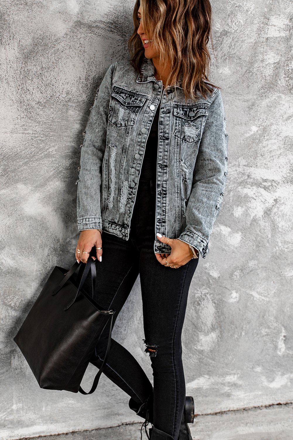 Gray distressed jean jacket featuring a turn-down collar and button closure, perfect for casual winter wear.