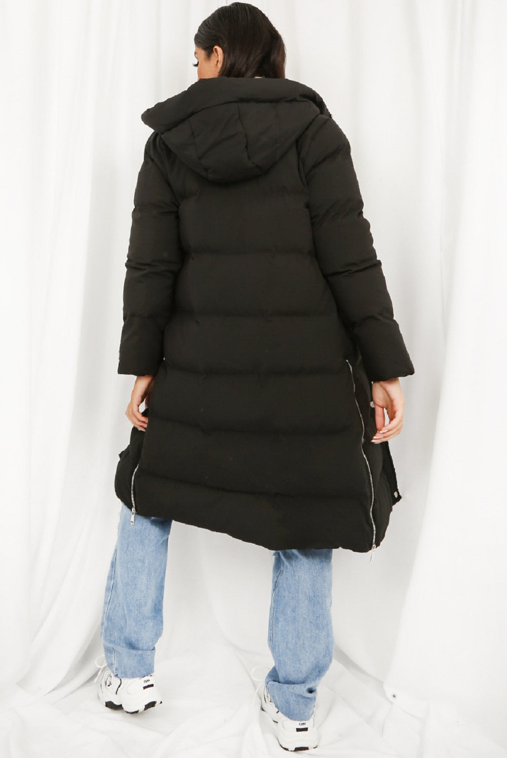 A stylish Hooded Longline Puffer Coat in black, featuring a zip closure and side pockets, perfect for winter wear.