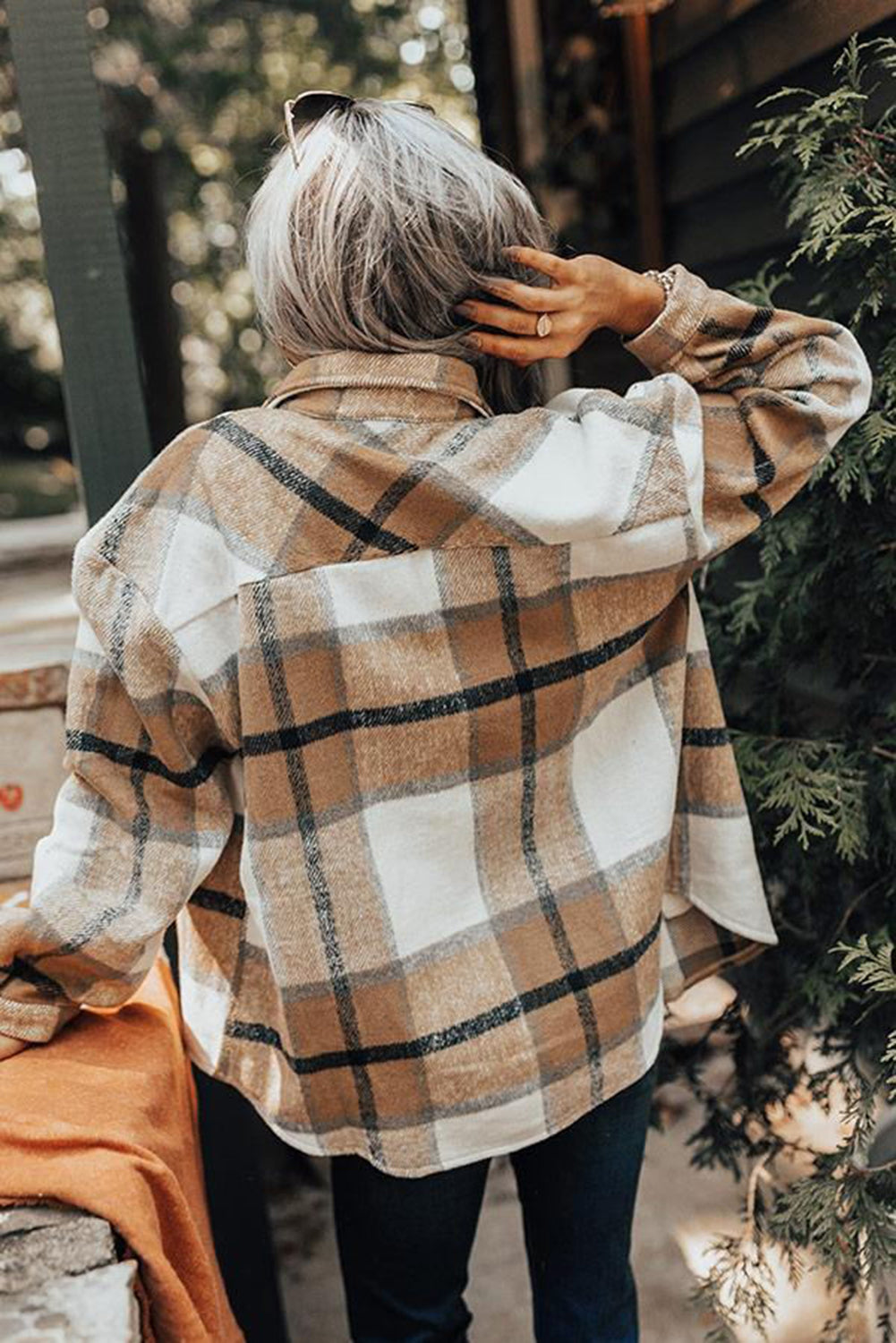 Khaki button-up pocket plaid shacket displayed on a mannequin, featuring a stylish plaid pattern and front pockets.