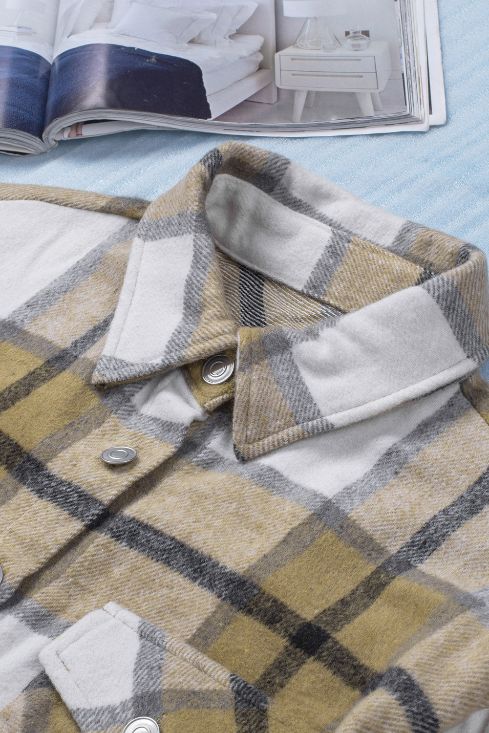 Khaki button-up pocket plaid shacket displayed on a mannequin, featuring a stylish plaid pattern and front pockets.