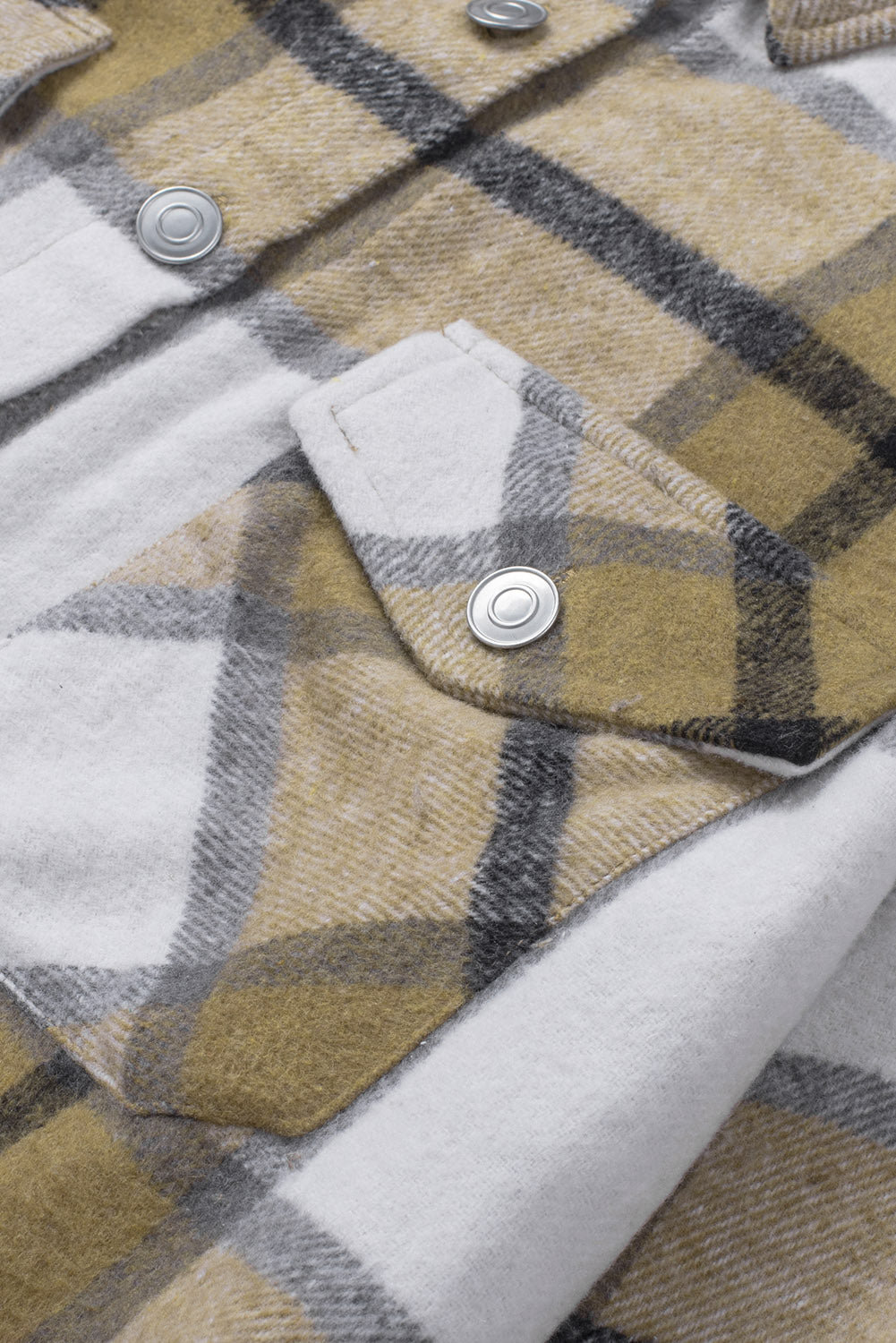 Khaki button-up pocket plaid shacket displayed on a mannequin, featuring a stylish plaid pattern and front pockets.